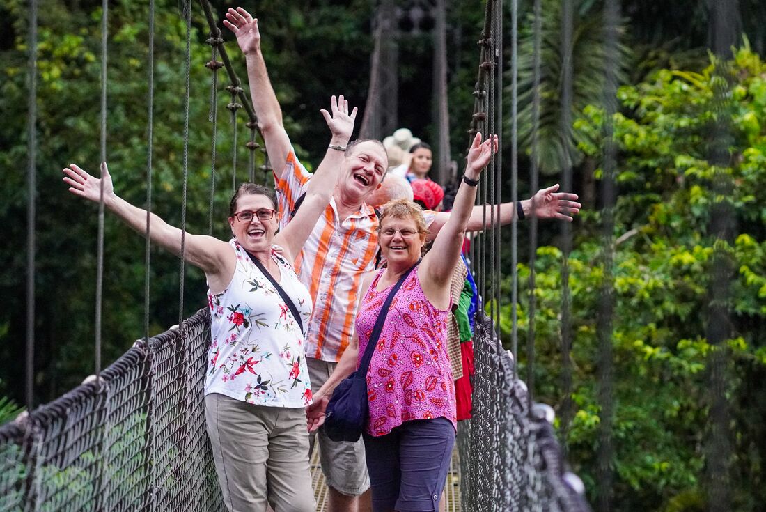 Travellers having a fun time on hanging bridge at La Fortuna, Costa Rica