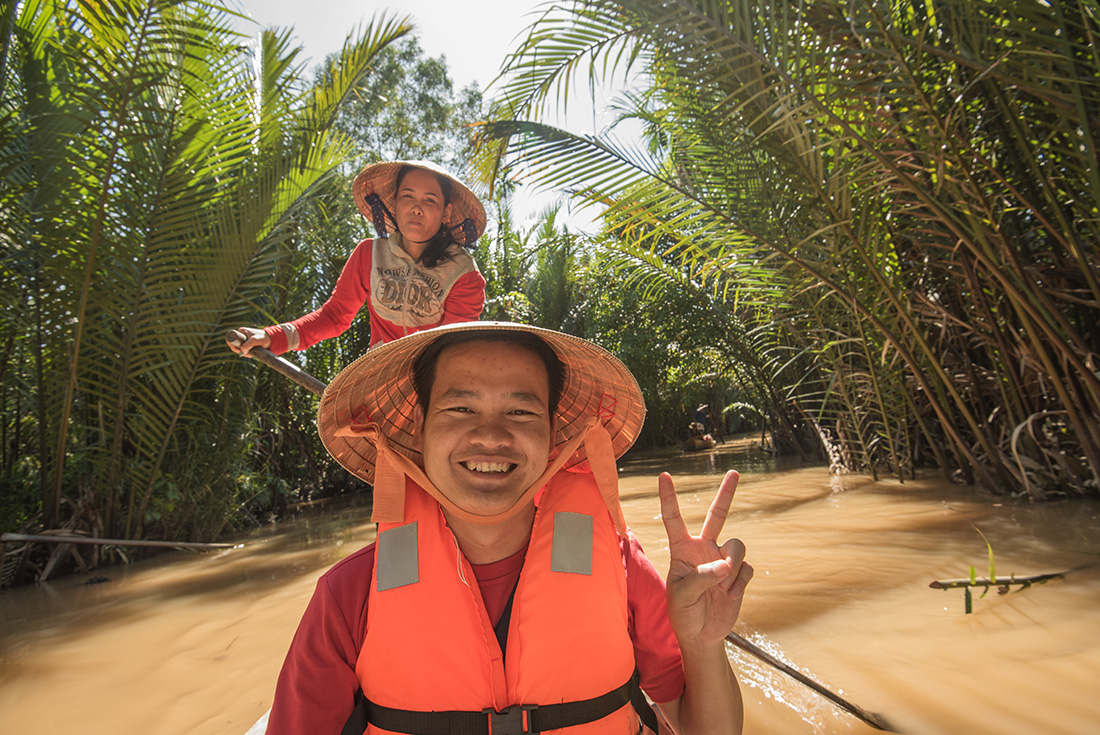 Passenger on a boat ride on the Mekong River, Vietnam on an Intrepid Travel tour.