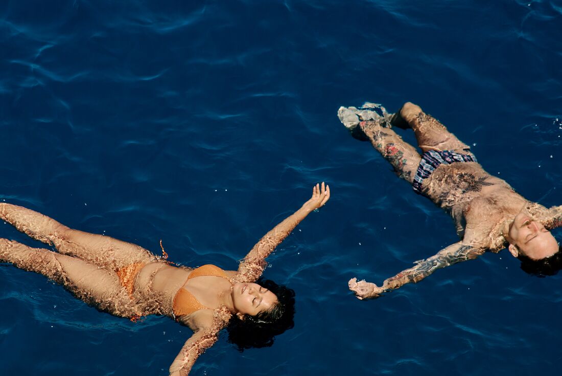 Travellers floating in the blue water on a boat trip in Korcula, Croatia