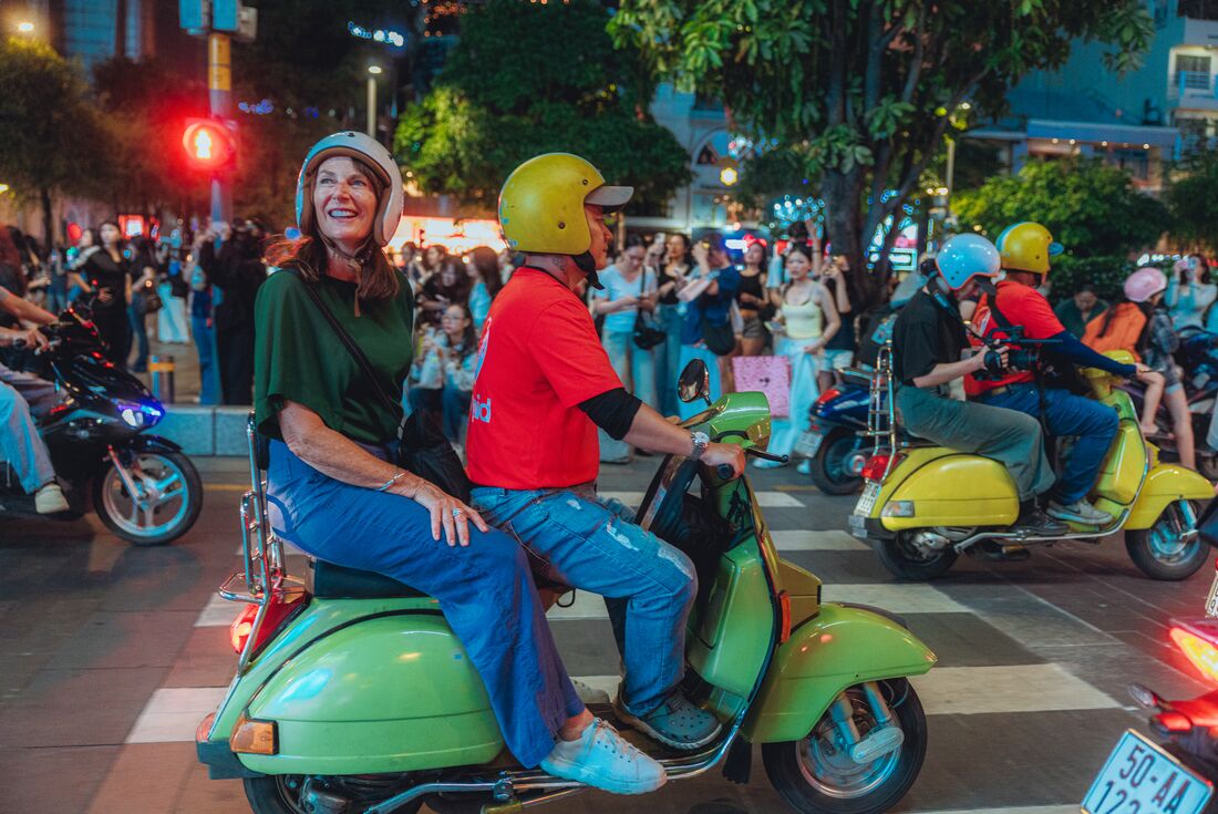 Travellers iding around Ho Chi Minh City on a scooter at night