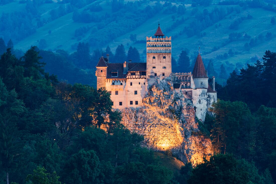 Bran Castle, commonly known as Dracula's Castle, lit from below at night in Transylvania Romania