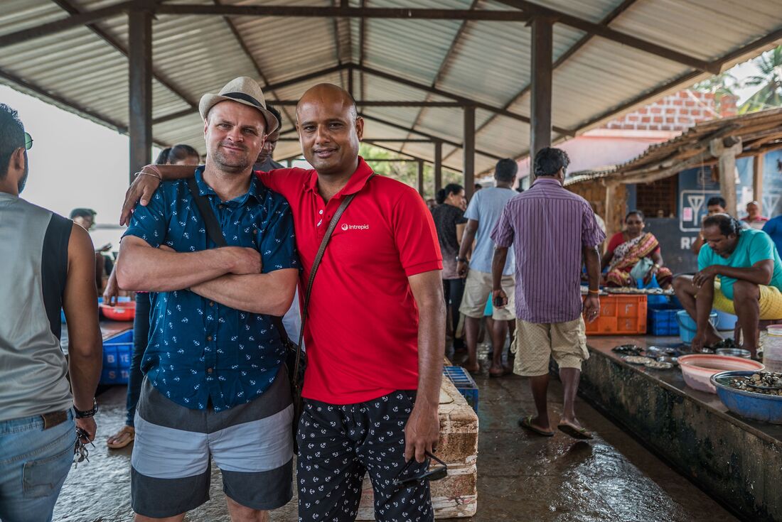 Intrepid leader and traveller embrace for a photo while exploring Goa, India