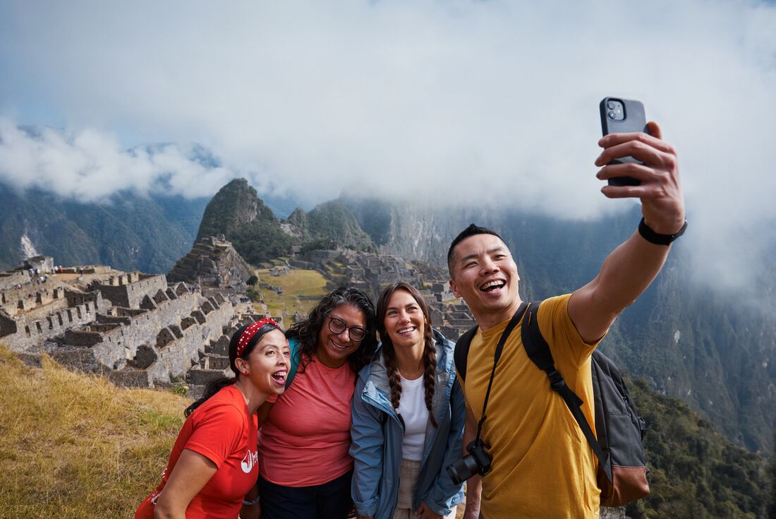 Intrepid travellers pose for a well deserved selfie at Machu Picchu