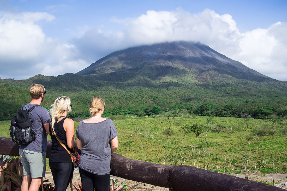 Travellers looking out over La Fortuna's Arenal Volcano
