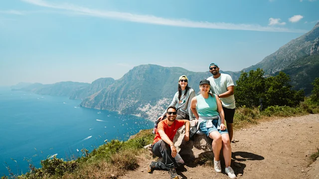 Intrepid group smiles as they pose along the Path of the Gods on the Amalfi Coast.