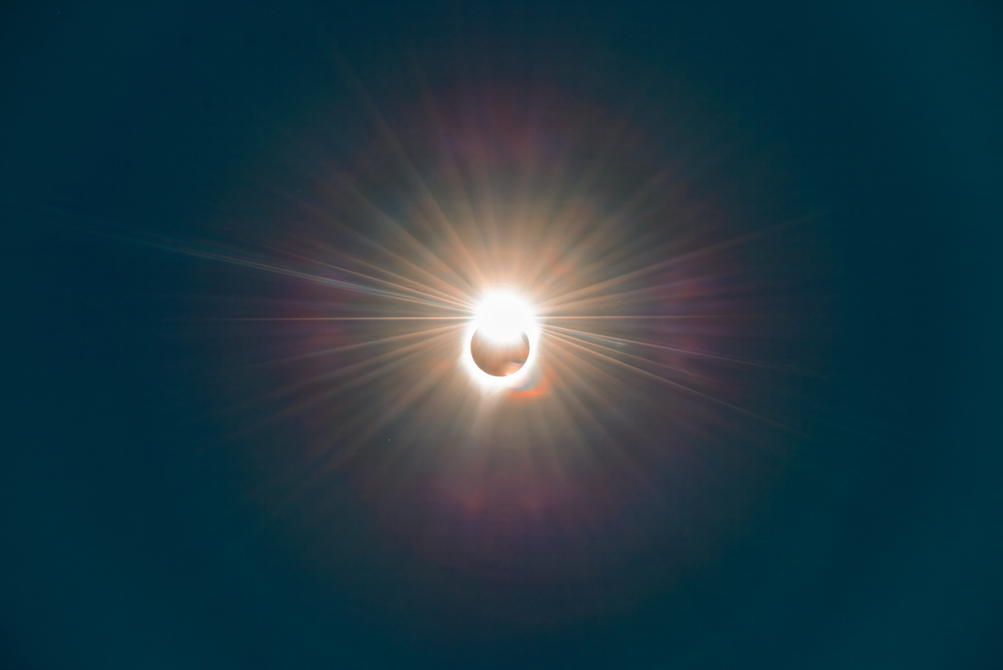 A total solar eclipse in progress as the sun begins to dissappear behind the moon