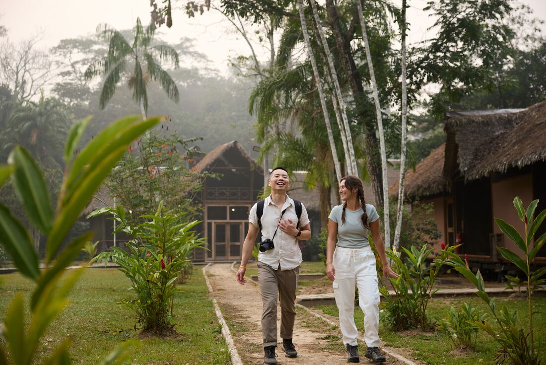 Intrepid travellers talk and laugh along the path away from the Amazon Jungle lodge