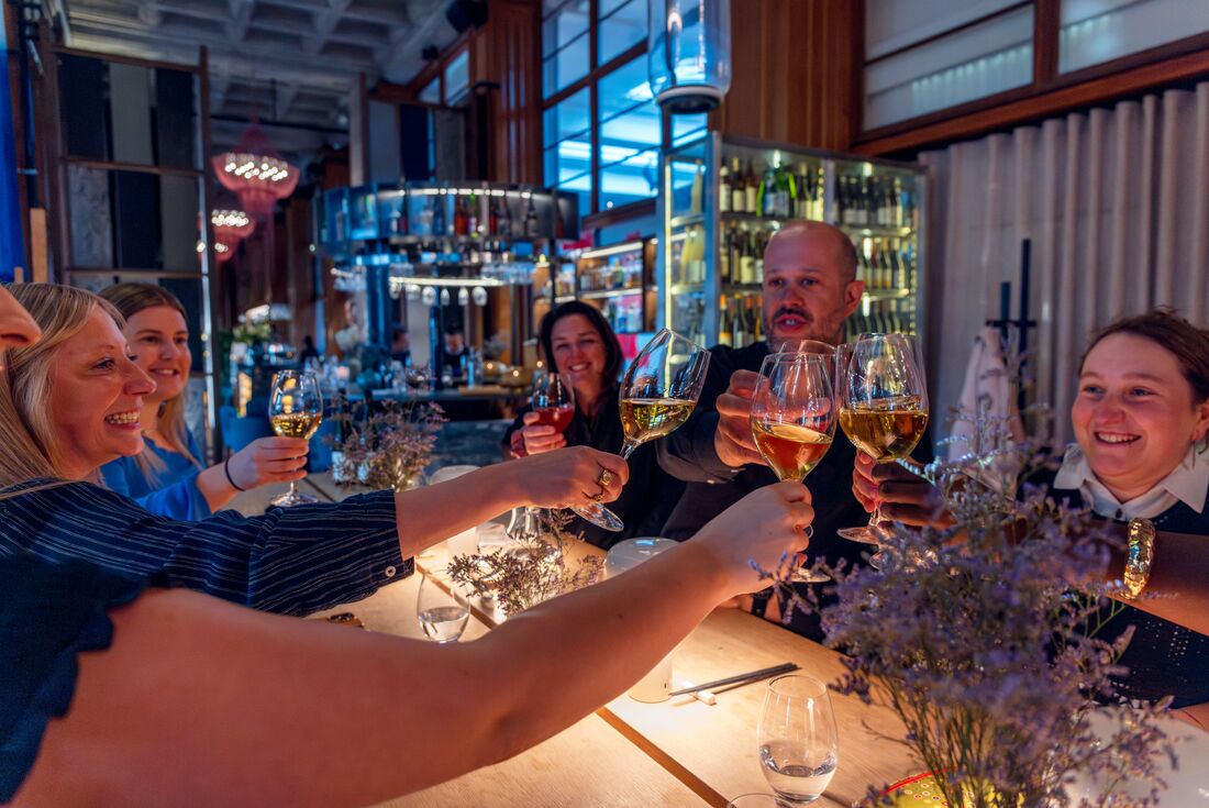 Intrepid travellers cheers wine during a tasting on Gothenburg walking tour in Sweden