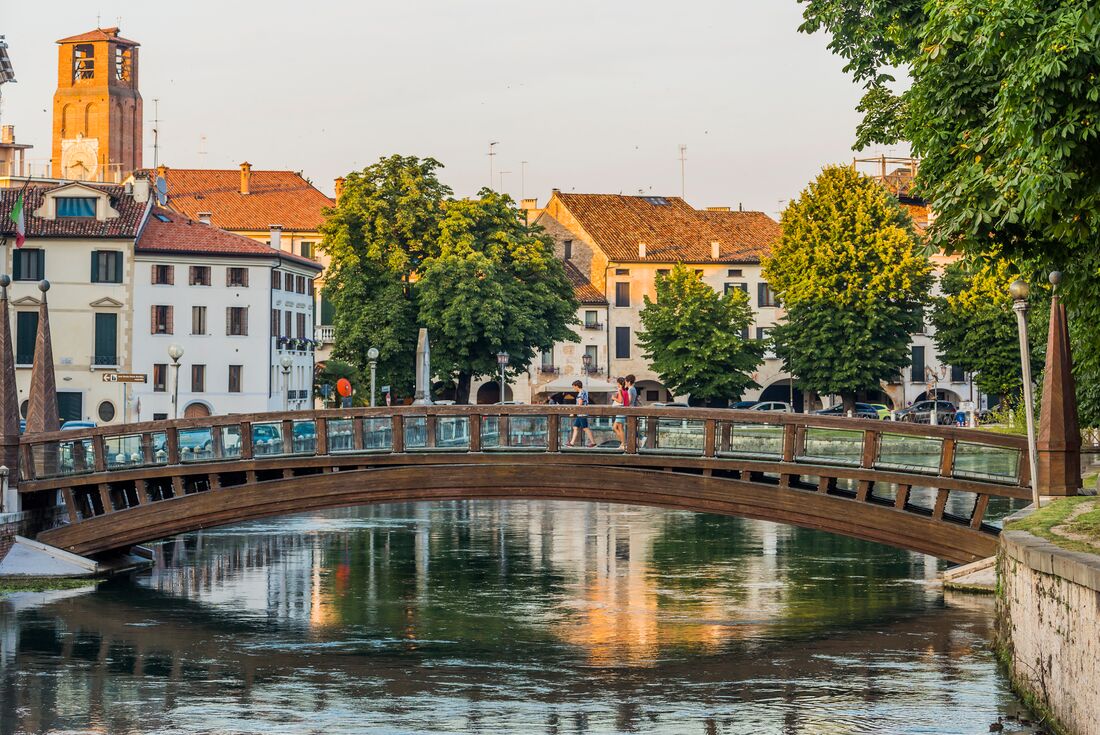 Intrepid travelllers and leader cross one of Treviso's iconic bridges