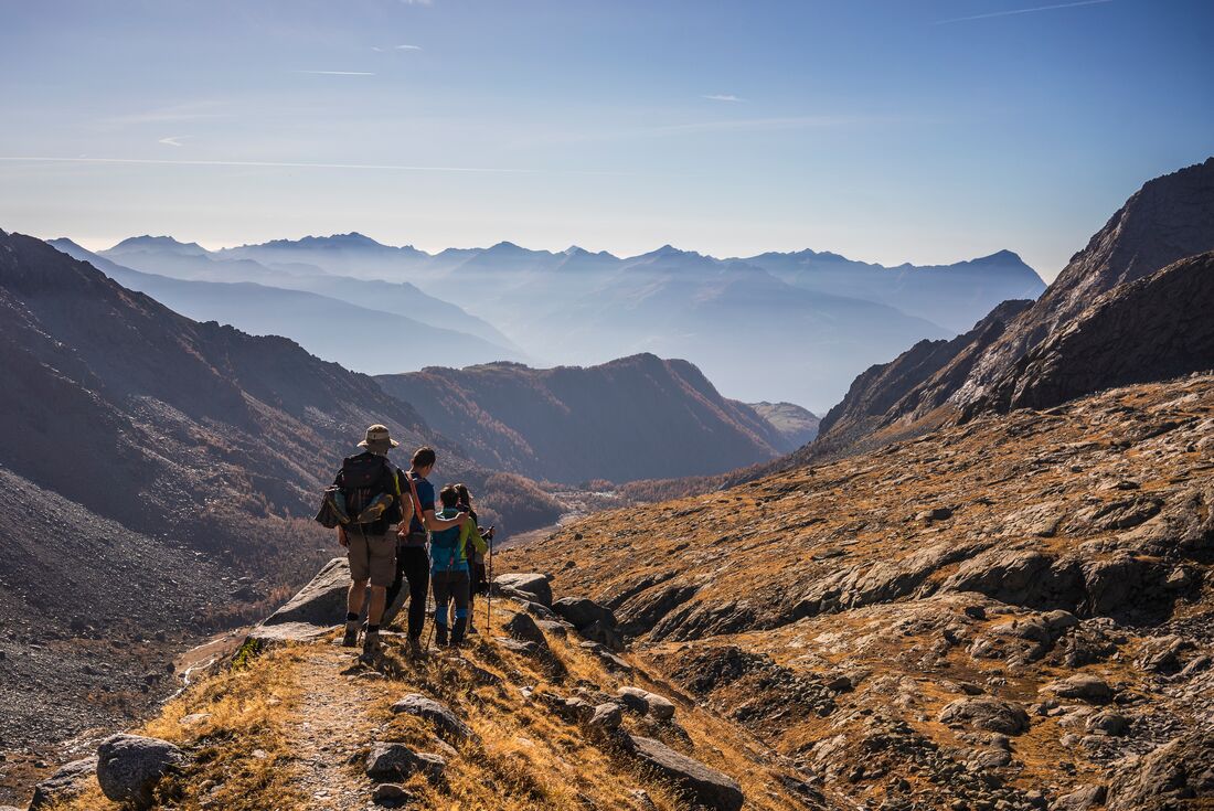 Intrepid travellers in hiking gear and walking sticks trekking through the majesty of Yellowstone National Park