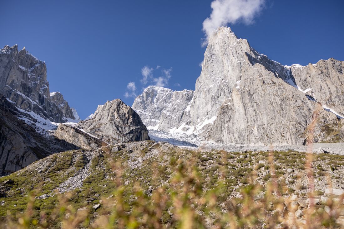 A granite peak of one of Karakoram Mountains towers over the scrub covered Nangma Valley seen on a hike