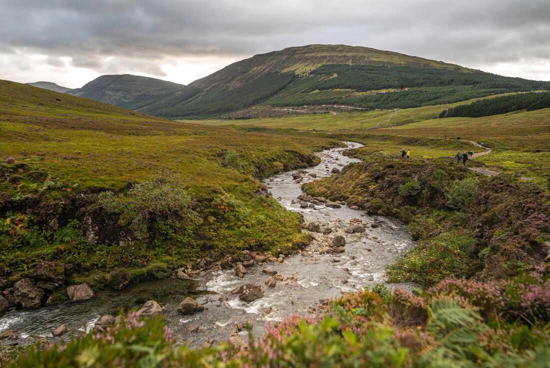 Isle of Skye landscape with a winding river cutting through glens and low mountains beyond in Scotland
