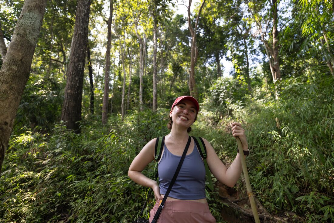 Traveller smiling with lush green forest behind them on a hilltribe trek, Mae Taeng District, Chiang Mai, Thailand