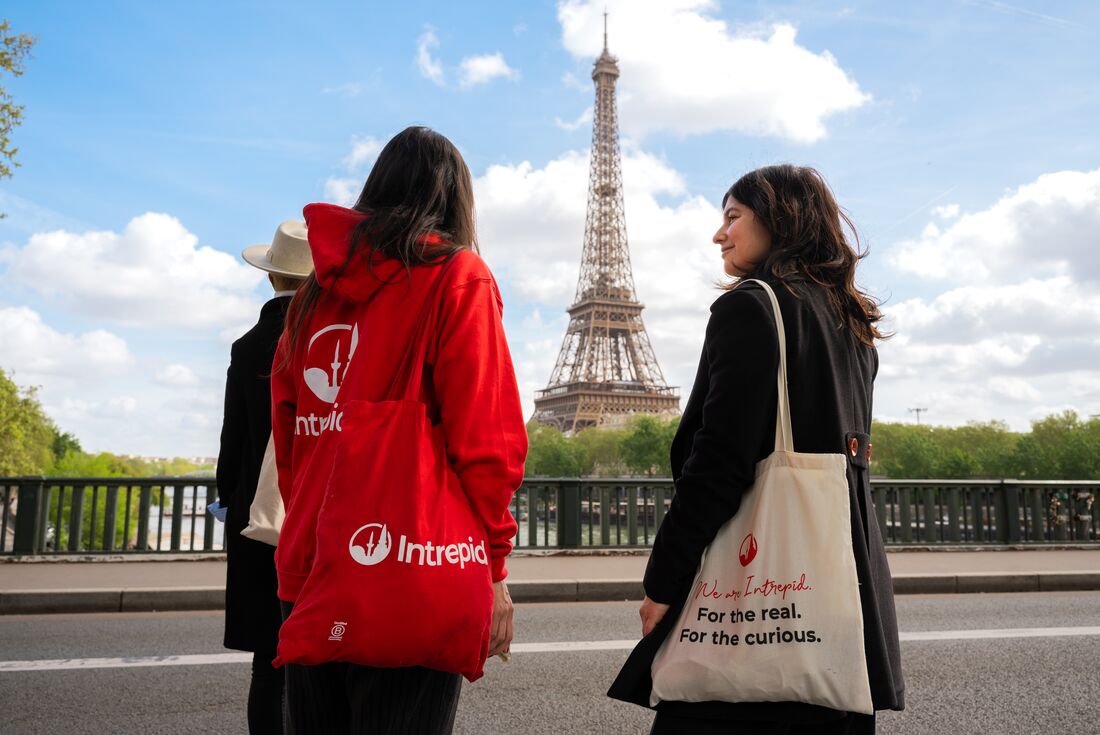 Three travellers enjoying a view of the Eiffel Tower in Paris, France.