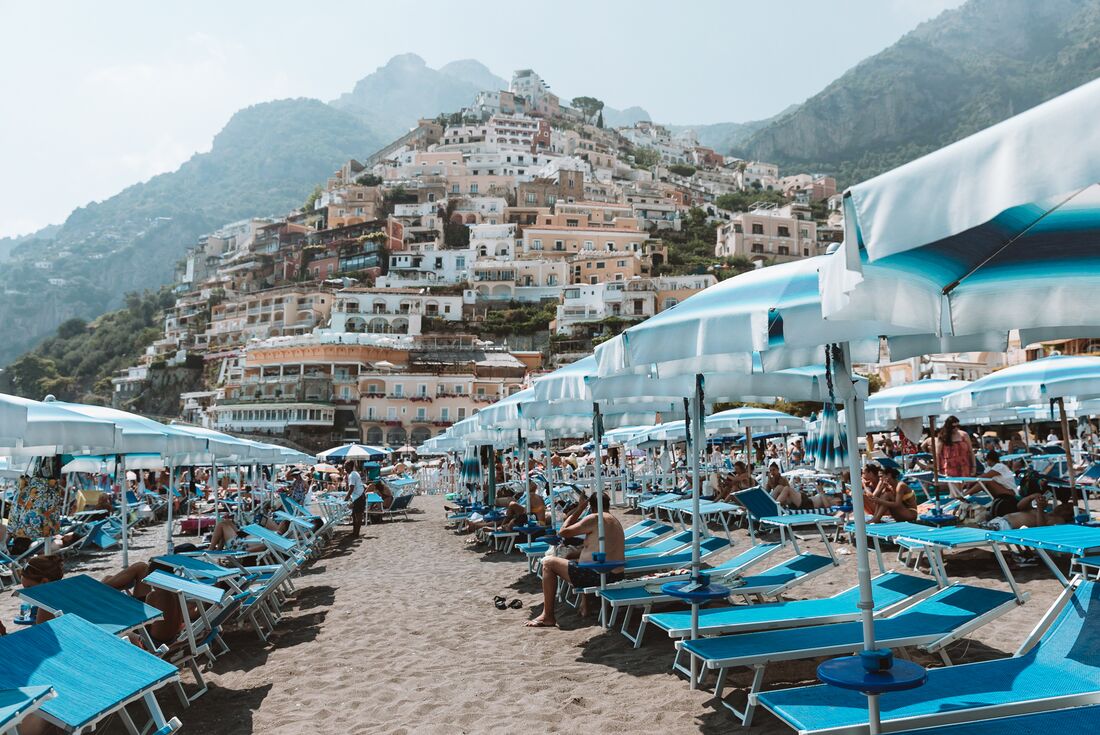 Beach of Minori with umbrellas and loungers on the Amalfi coast