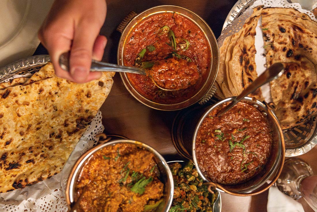 Flatlay spread of different curries in New Delhi 