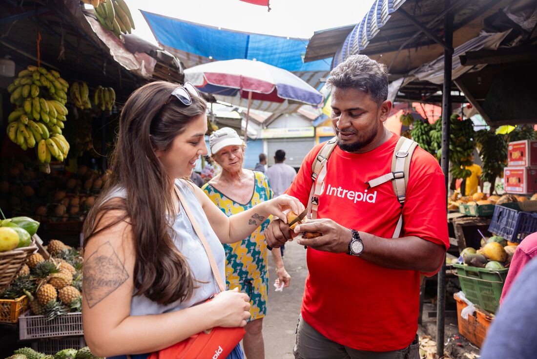 Travellers with guide during market wander and tasting in Kandy, Sri Lanka