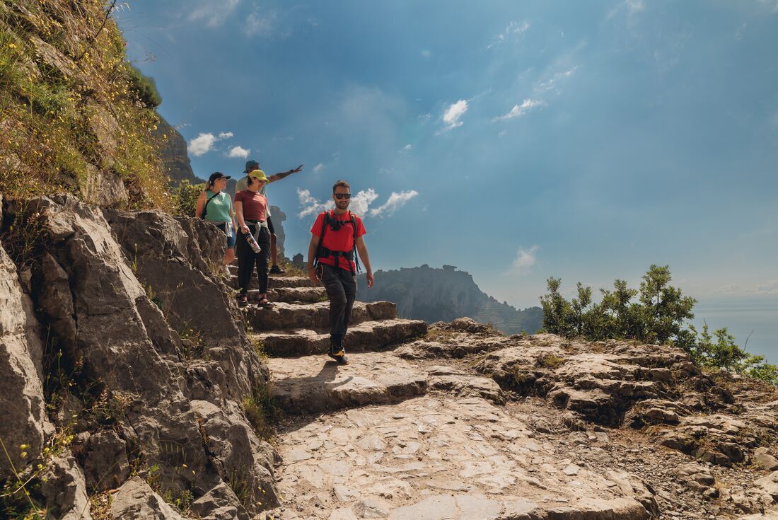 Leader with travellers on Path of the Gods hiking trail, Amalfi Coast, Italy