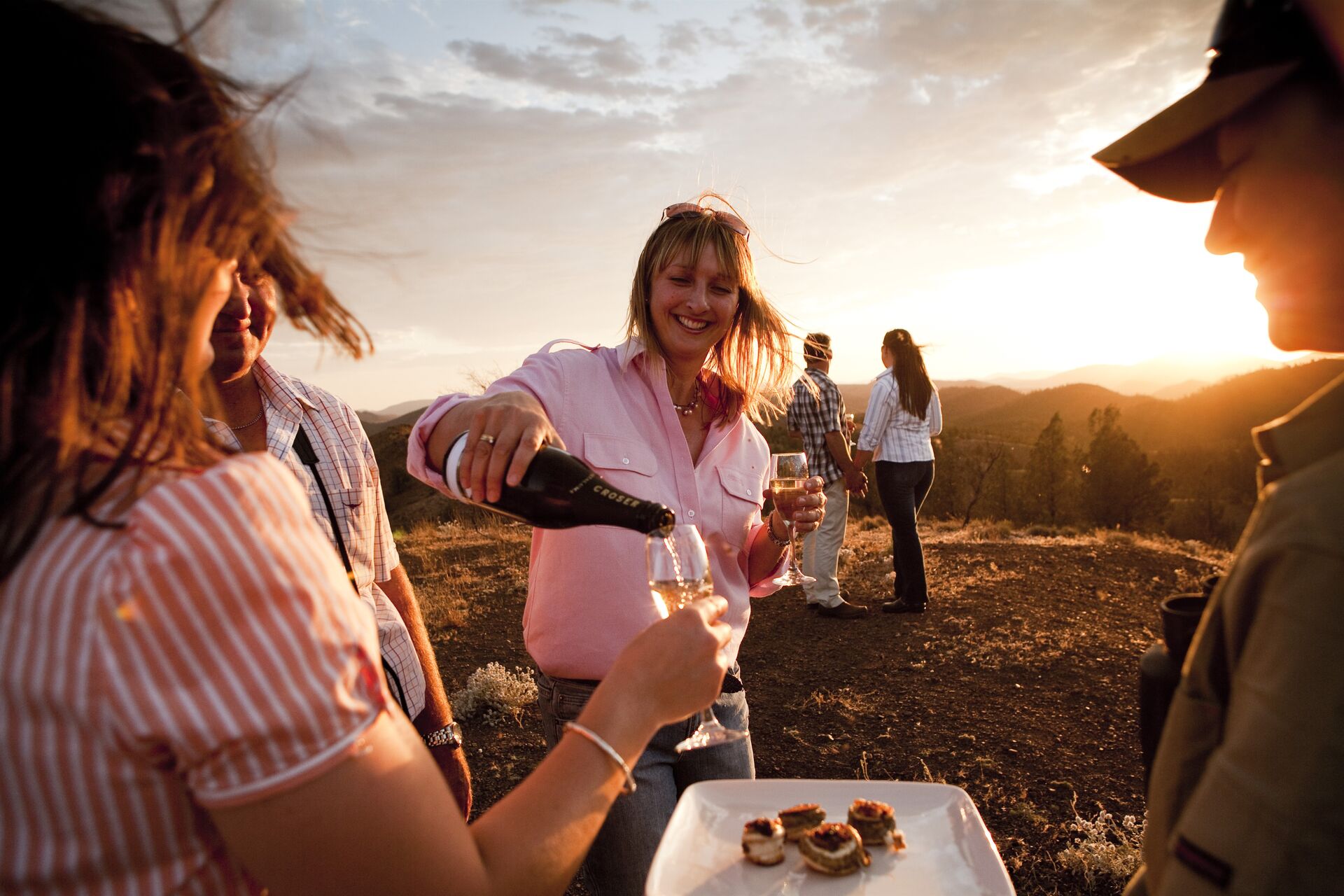 Sundown drinks and canape service on the hills at sunset