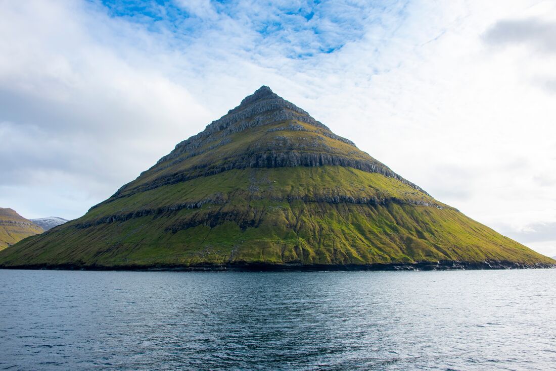 Towering conical cliffs of Bordoy Island in the Faroe Islands