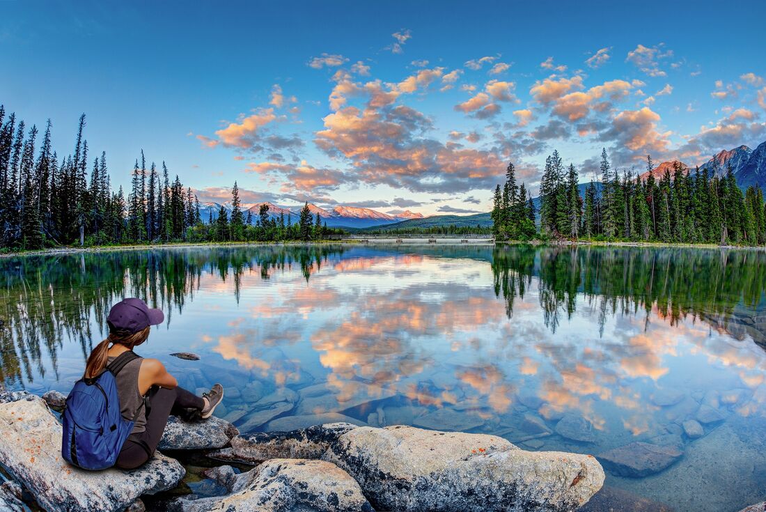 Traveller enjoys sunrise over Pyramid Lake in Jasper National Park Canada