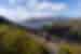 Group of Intrepid travellers look out over Wine Glass Bay from a lookout in Tasmania