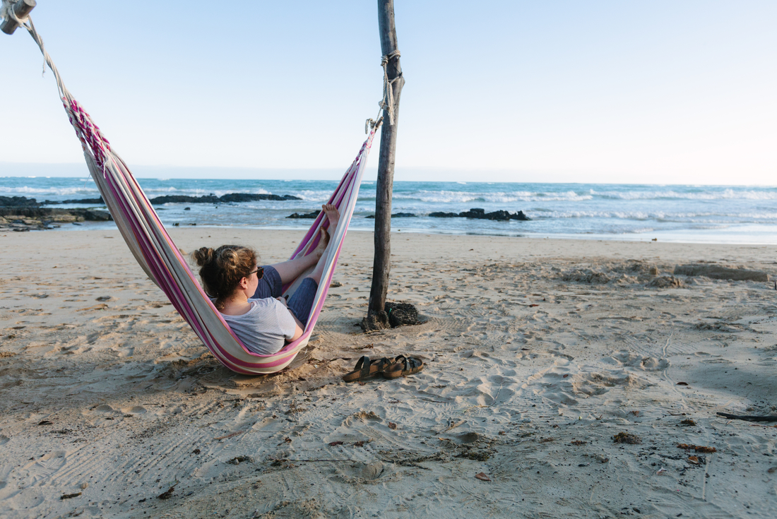 Traveller swinging in a hammock, Galapagos Islands, Ecuador