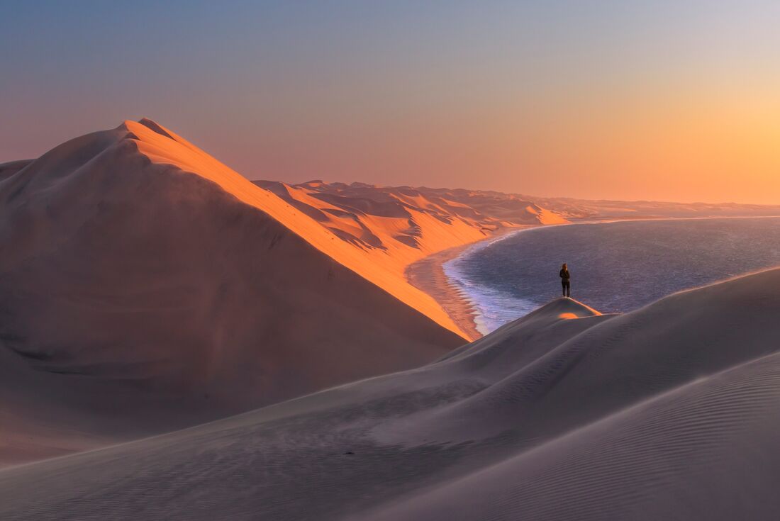 Take in the view from the towering dunes of Sandwich Harbour on Namibia's Atlantic Coast