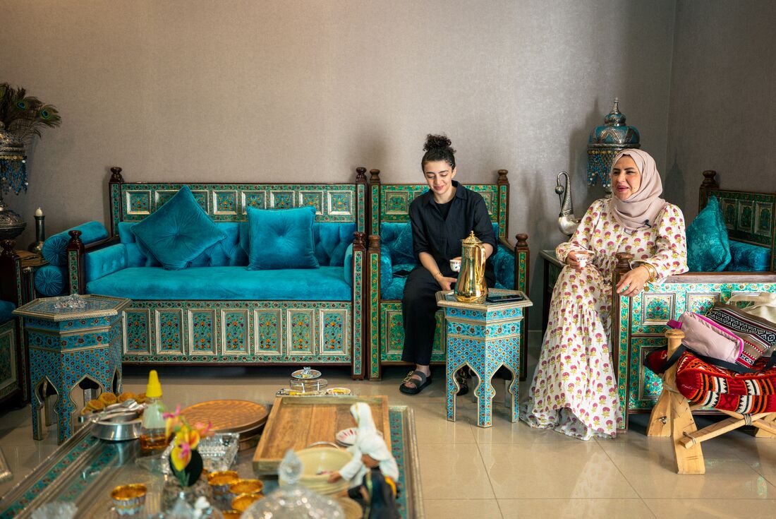 Locals sitting and smiling at a home visit in Riyadh, Saudi Arabia