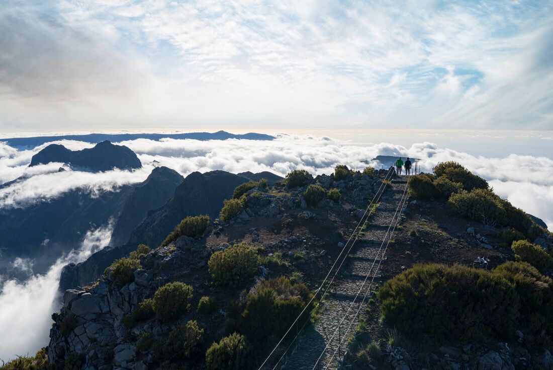 Intrepid travellers look out after hiking to the top of Madeira at Pico Ruivo