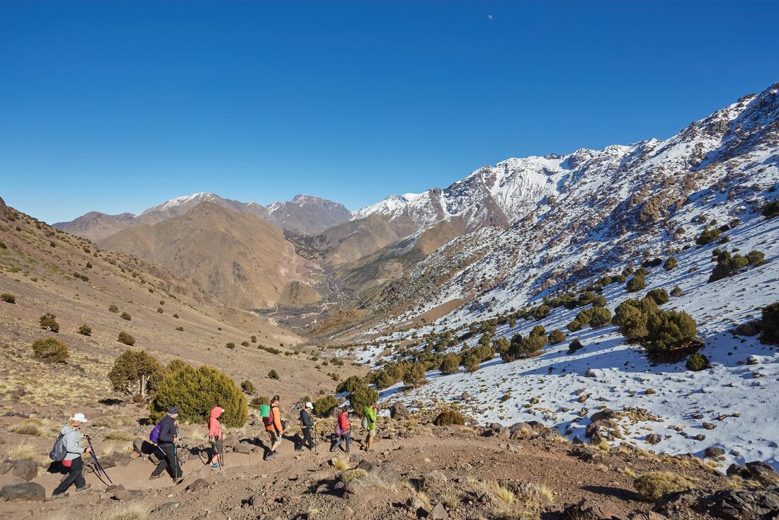 Intrepid travellers hiking in Toubkal National Park toward Sidi Chamharouch