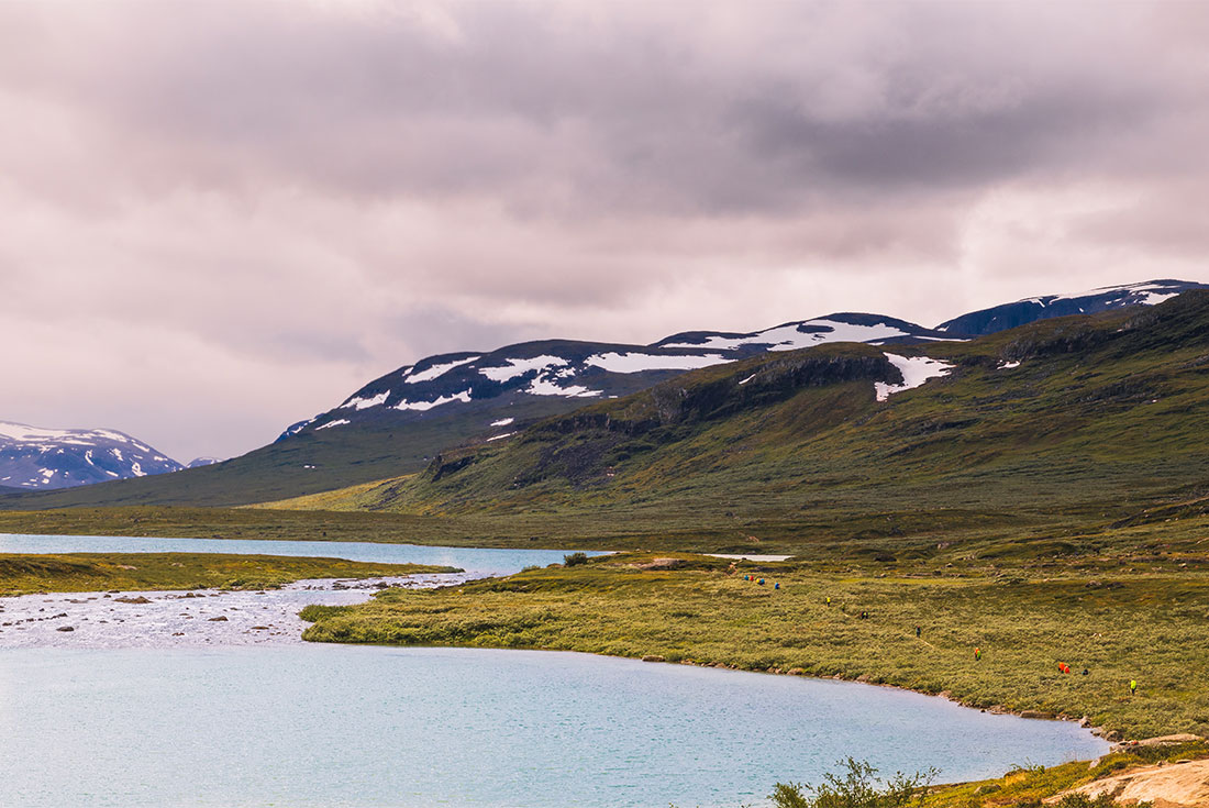 Intrepid traveller hike a path through the landscape of Abisko National Park in northern Sweden