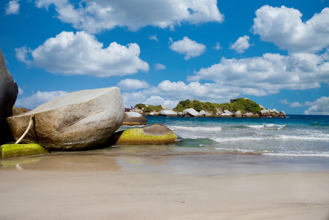Large rocks on the beach Beach at Tayrona National Park on a blue sky backdrop, Santa Marta, Colombia
